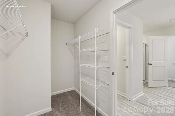 a view of walk in closet with empty racks