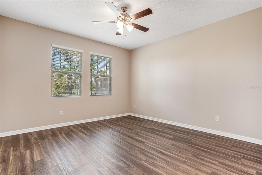 2520 Plumadore Drive Grand Island, FL 32735 - Photo 14 of 19 wooden floor in an empty room with a window