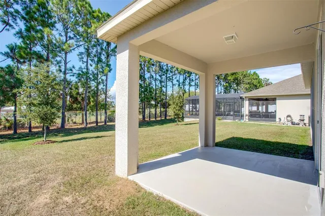 a view of a house with backyard and a garden