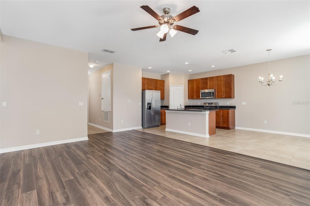 2520 Plumadore Drive Grand Island, FL 32735 - Photo 4 of 19 a view of a kitchen with a stove cabinets and wooden floor