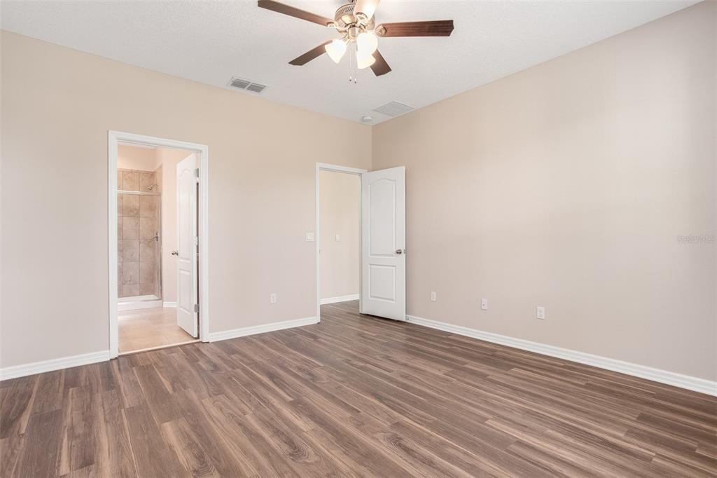 2520 Plumadore Drive Grand Island, FL 32735 - Photo 7 of 19 a view of an empty room with wooden floor