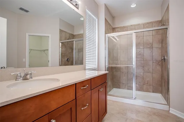 a bathroom with a shower sink and mirror