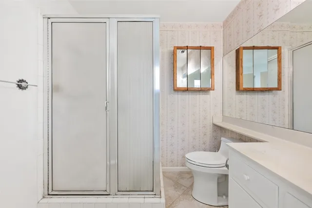 a white toilet sitting next to a bathroom sink