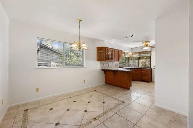 a kitchen with kitchen island a counter top space appliances and cabinets