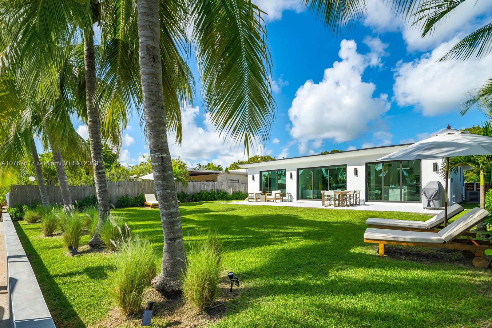 a view of a house with a backyard porch and sitting area