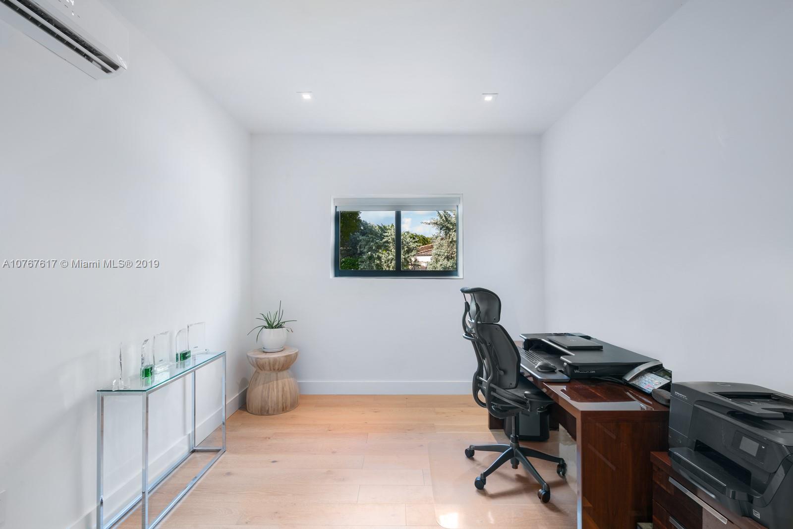 1320 Cleveland Road Miami Beach, FL 33141 - Photo 15 of 16 a view of a workspace with furniture and a window