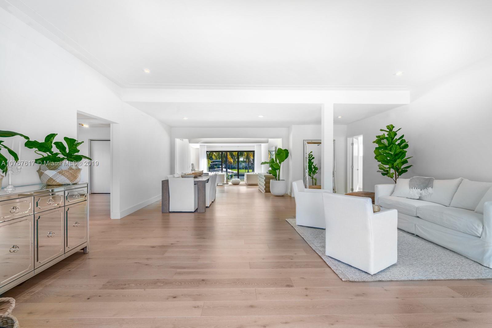 1320 Cleveland Road Miami Beach, FL 33141 - Photo 3 of 16 a living room with furniture and a wooden floor