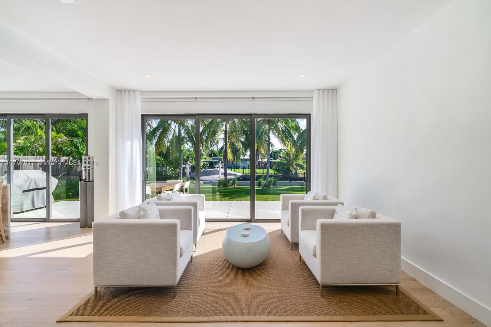 1320 Cleveland Road Miami Beach, FL 33141 - Photo 4 of 16 a living room with furniture and a floor to ceiling window