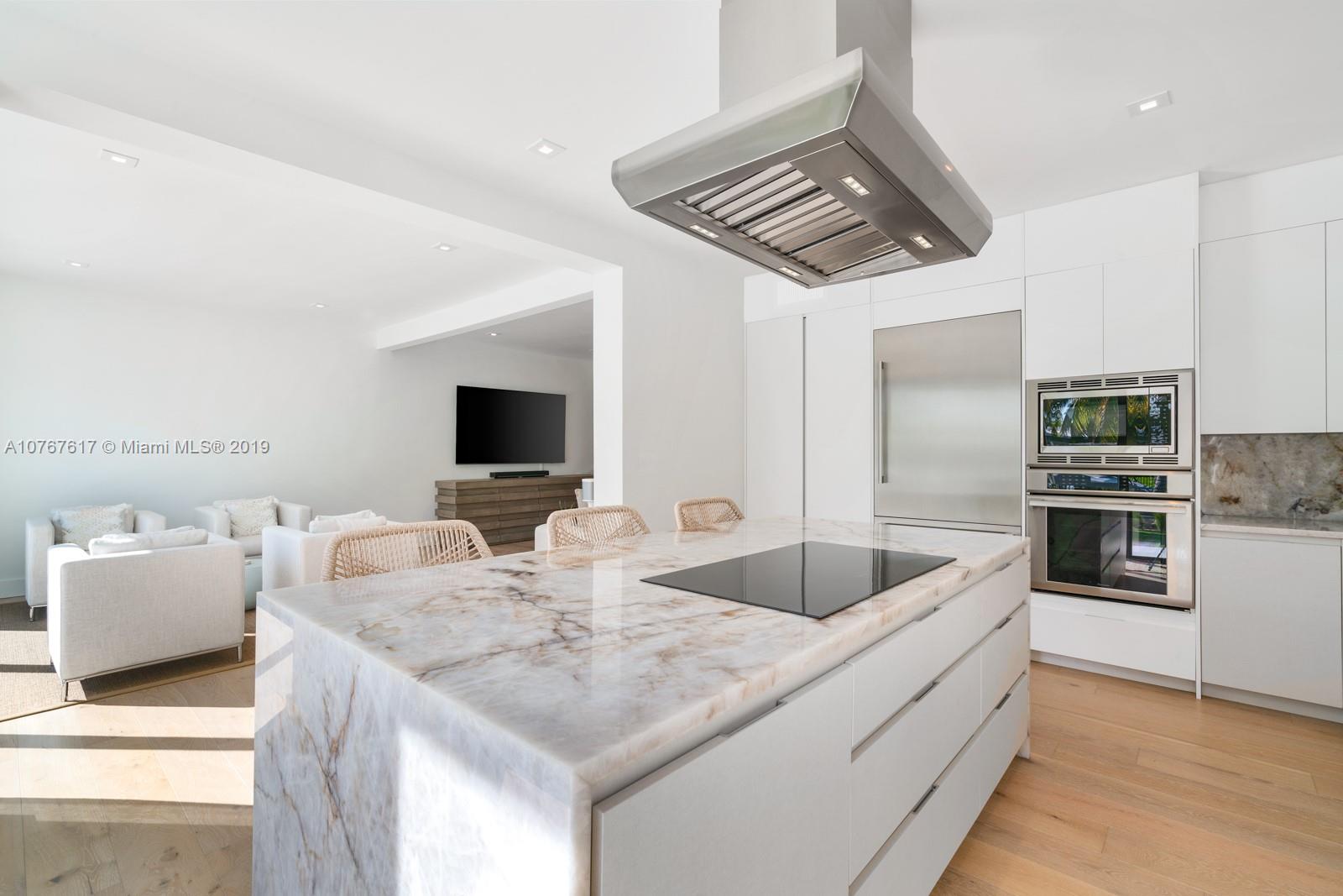 1320 Cleveland Road Miami Beach, FL 33141 - Photo 6 of 16 a kitchen with stainless steel appliances granite countertop a sink and a refrigerator