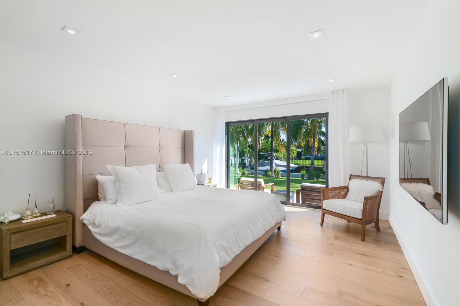 1320 Cleveland Road Miami Beach, FL 33141 - Photo 8 of 16 a bedroom with a bed and a flat screen tv