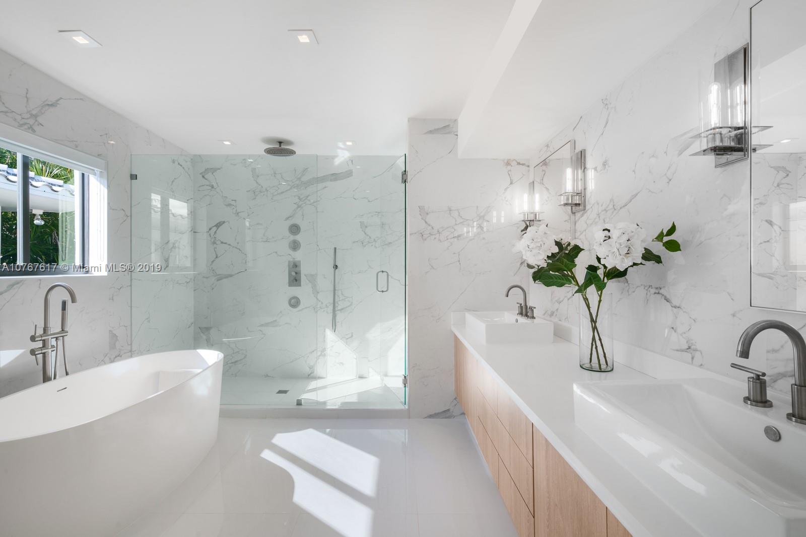 1320 Cleveland Road Miami Beach, FL 33141 - Photo 9 of 16 a bathroom with a bathtub sink and mirror