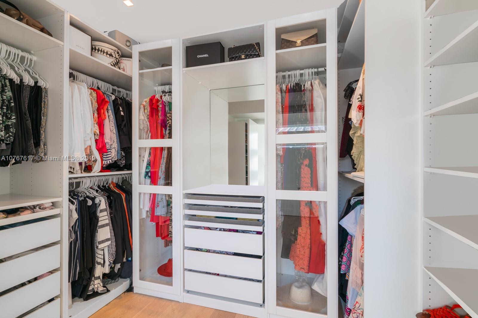 1320 Cleveland Road Miami Beach, FL 33141 - Photo 10 of 16 a view of walk in closet with clothes and shoes