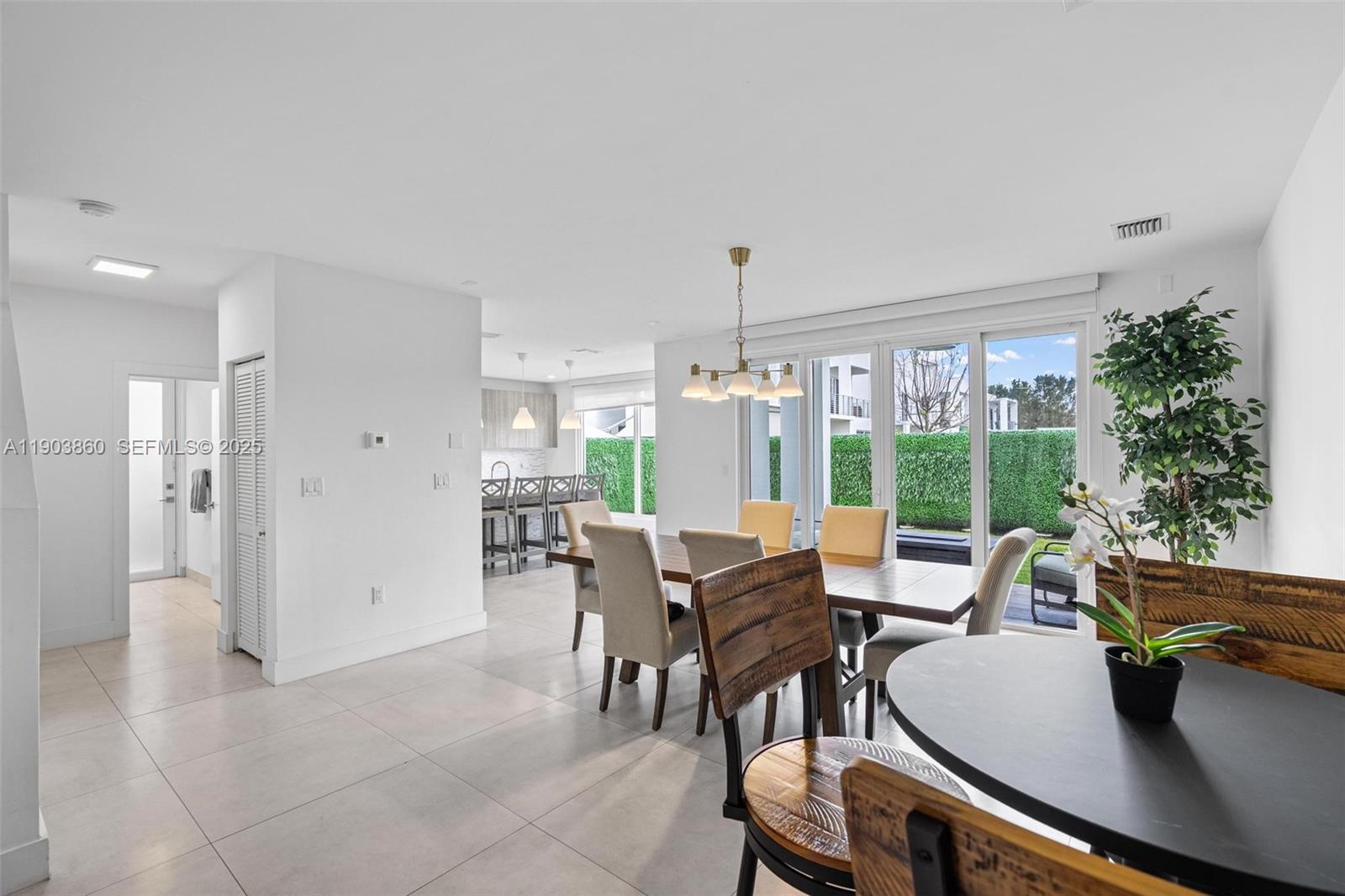 10330 Northwest 68th Street Doral, FL 33178 - Photo 12 of 60 a view of a dining room with furniture window and outside view