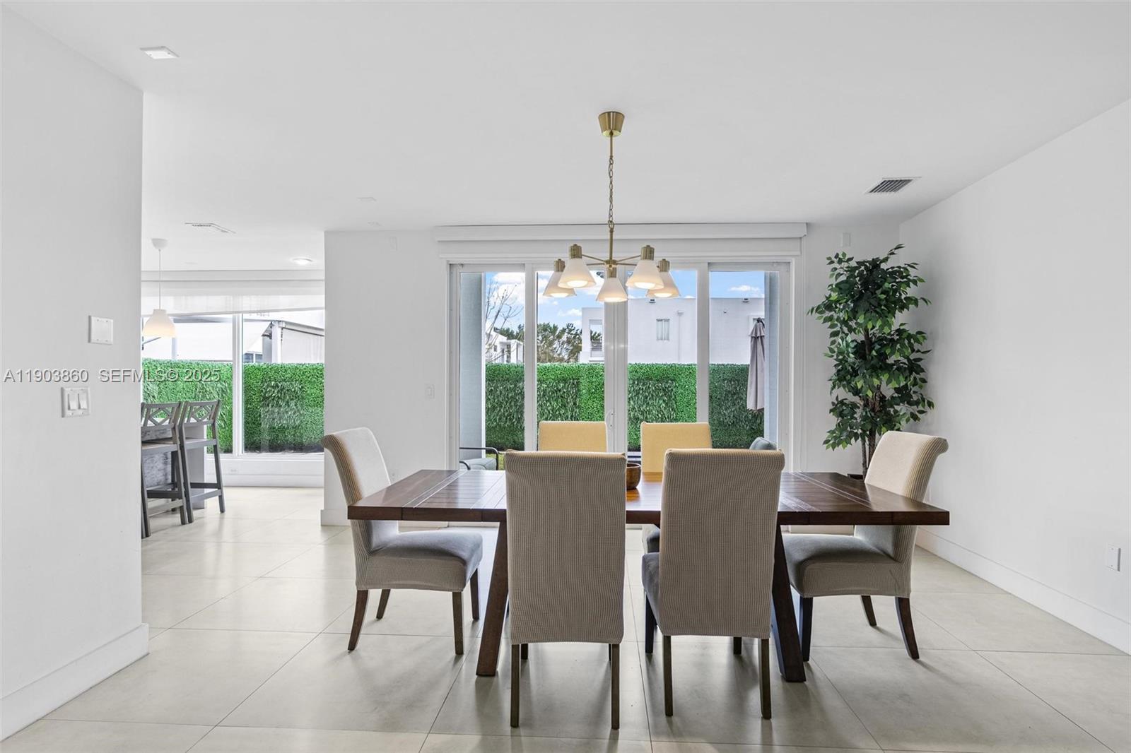 10330 Northwest 68th Street Doral, FL 33178 - Photo 13 of 60 a view of a dining room with furniture window and outside view