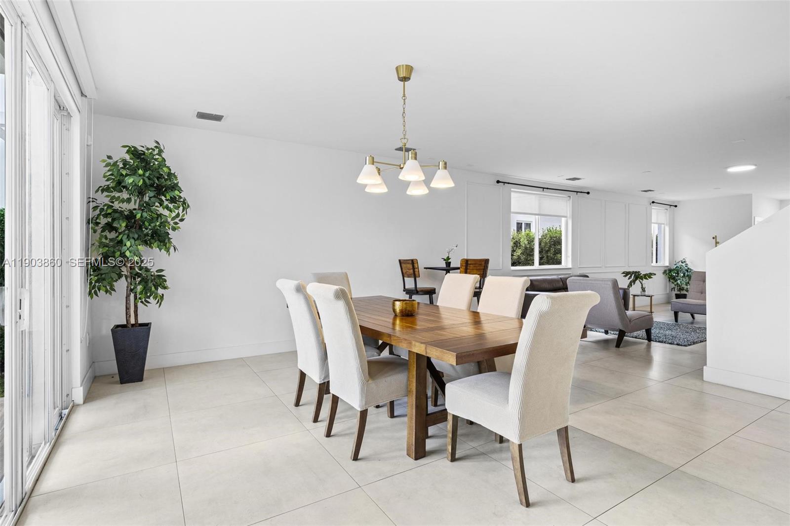 10330 Northwest 68th Street Doral, FL 33178 - Photo 15 of 60 a view of a dining room with furniture and chandelier