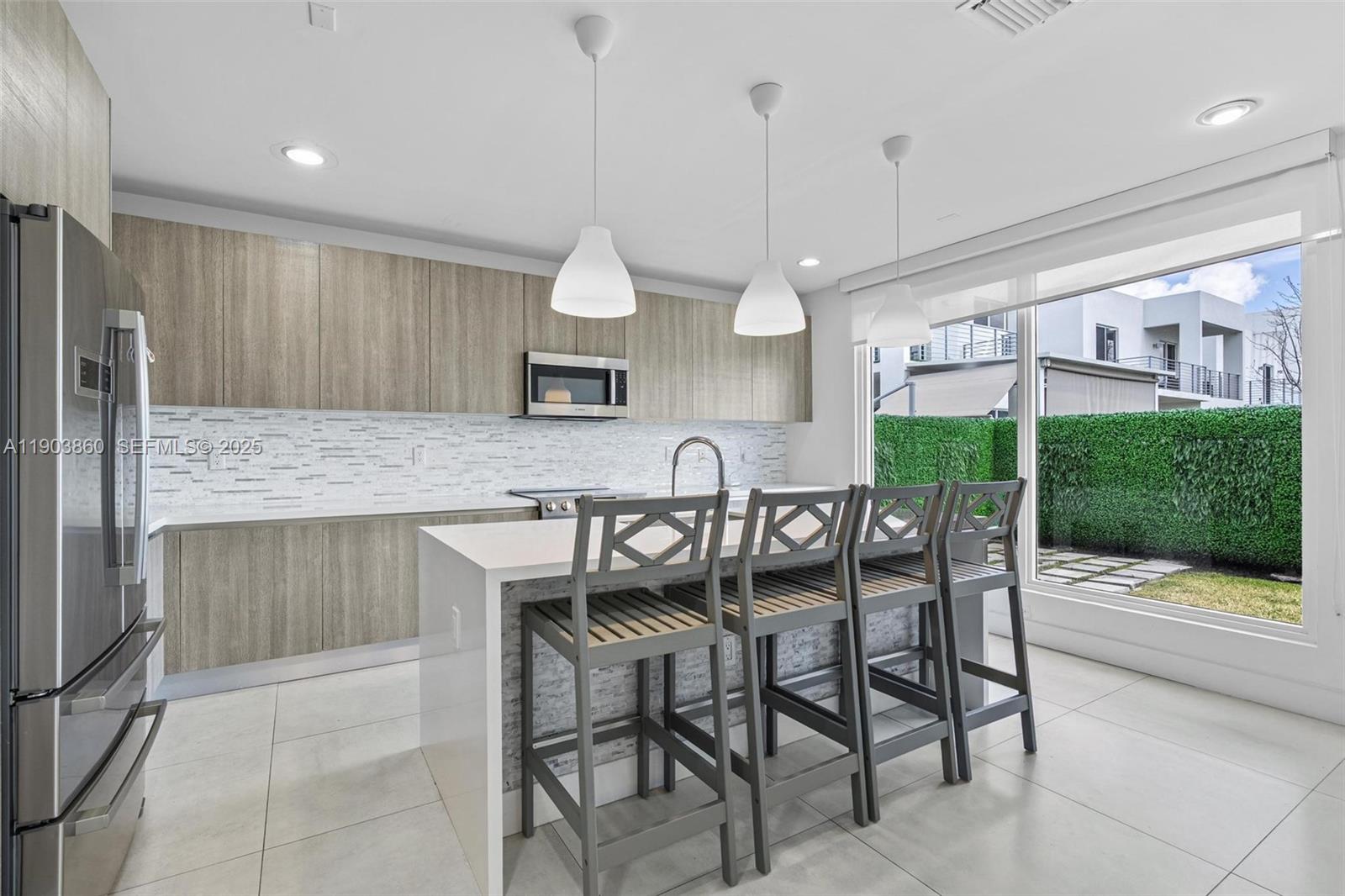 10330 Northwest 68th Street Doral, FL 33178 - Photo 17 of 60 a open kitchen with a table and chairs in it