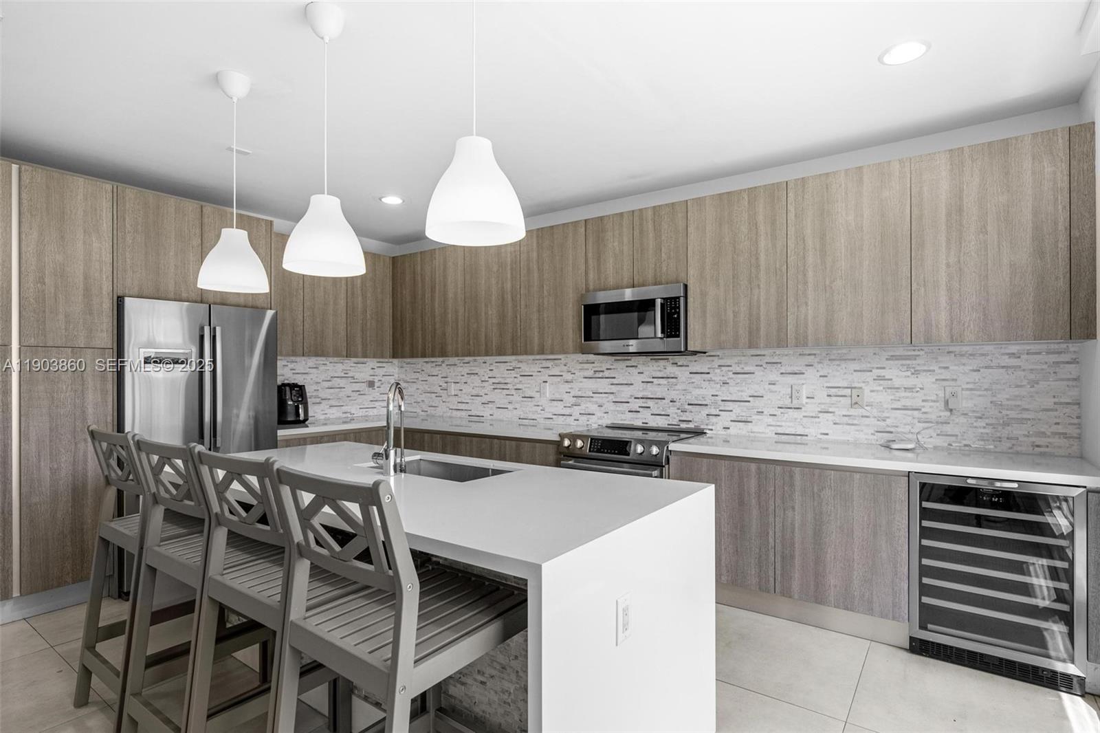 10330 Northwest 68th Street Doral, FL 33178 - Photo 18 of 60 a kitchen with a table a sink and refrigerator