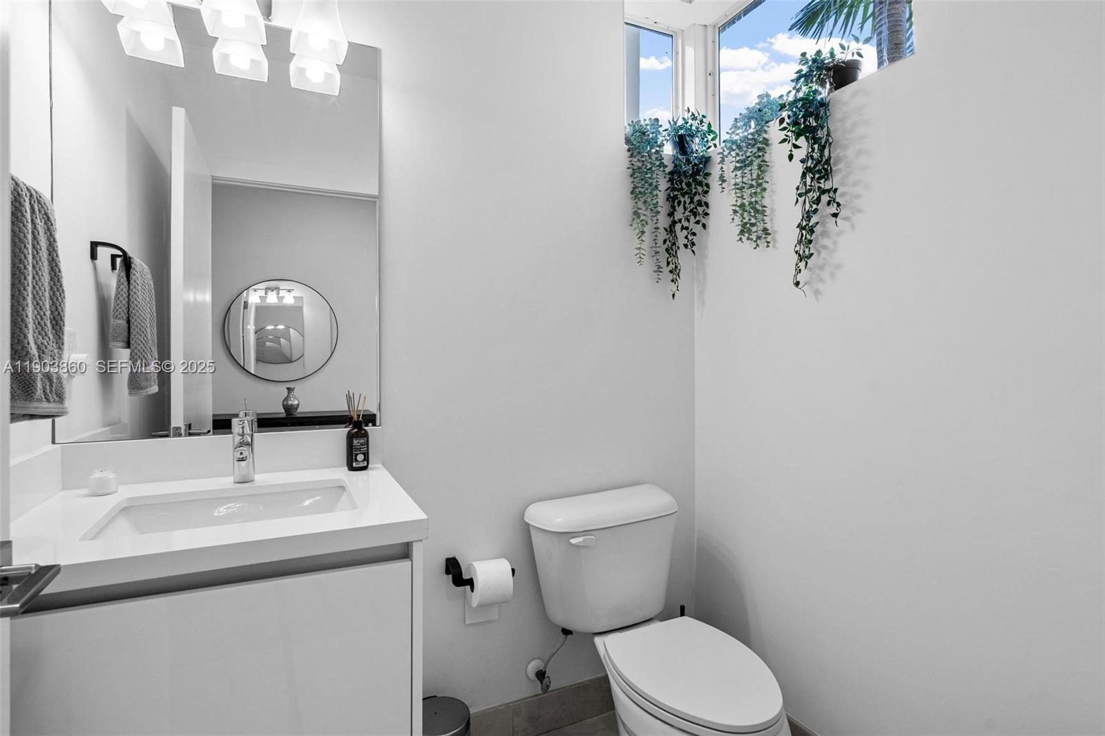 10330 Northwest 68th Street Doral, FL 33178 - Photo 22 of 60 a bathroom with a toilet sink and mirror