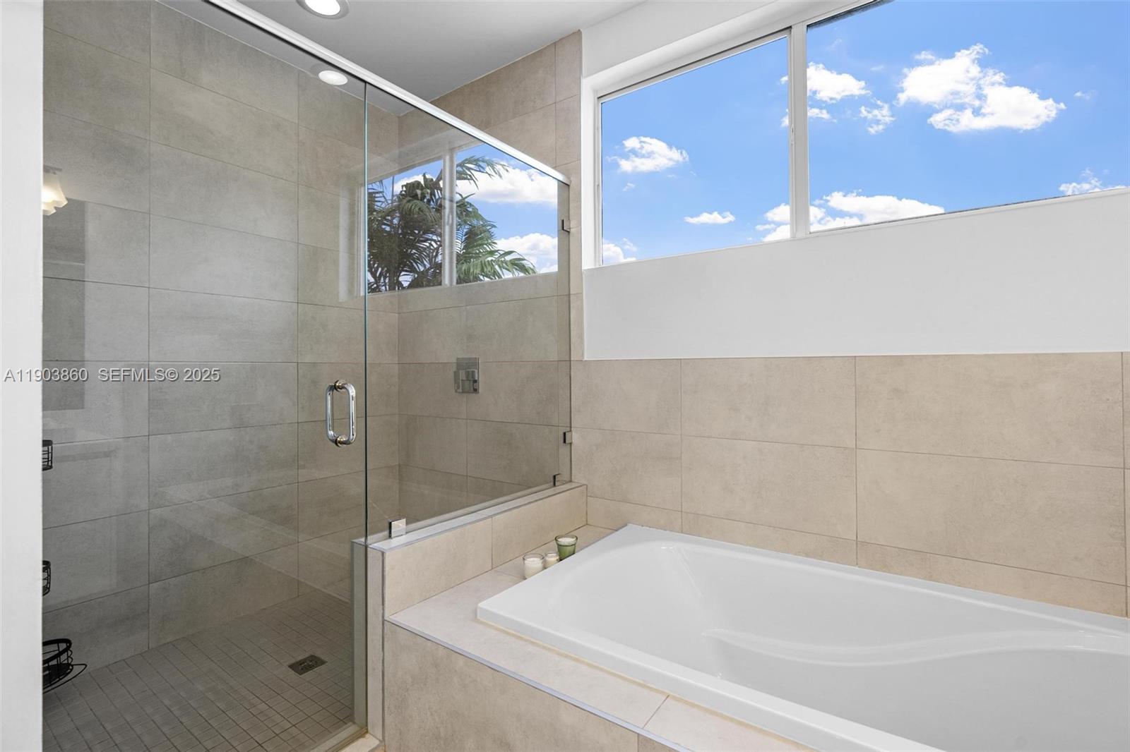 10330 Northwest 68th Street Doral, FL 33178 - Photo 30 of 60 a bathroom with a bathtub and shower