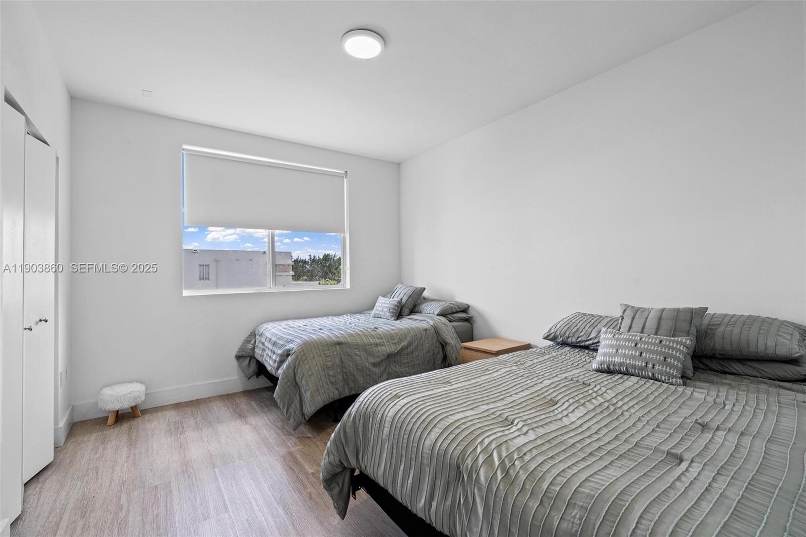 10330 Northwest 68th Street Doral, FL 33178 - Photo 34 of 60 a bedroom with two beds and a window