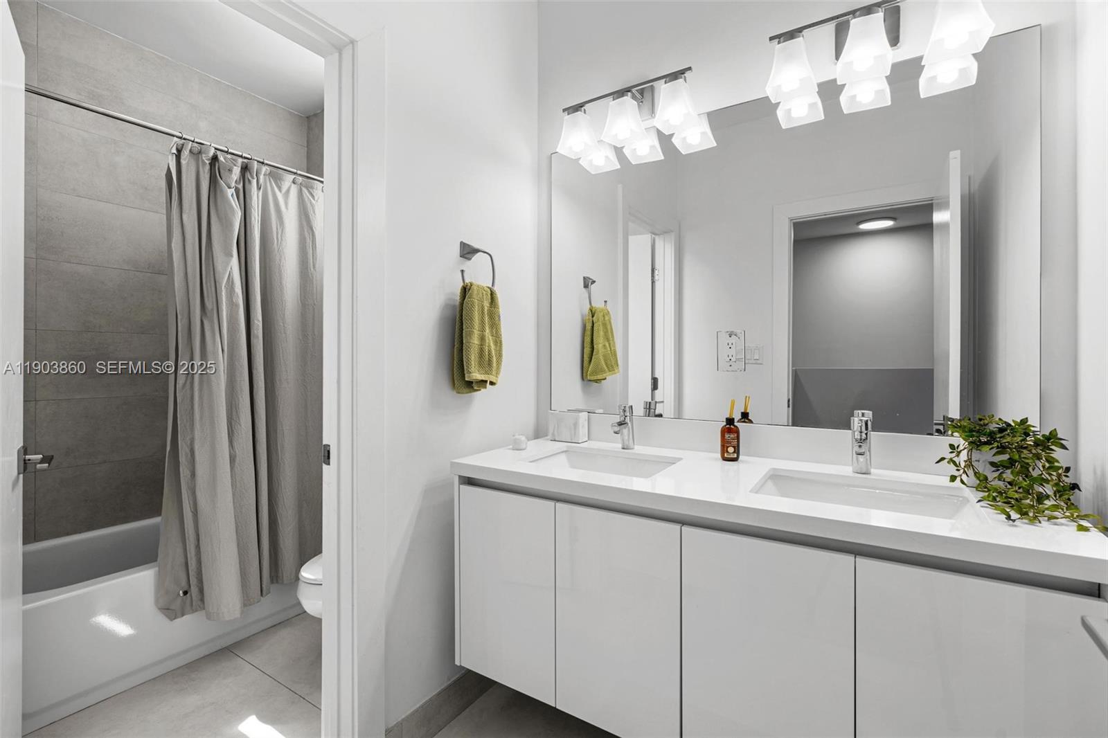 10330 Northwest 68th Street Doral, FL 33178 - Photo 35 of 60 a bathroom with a double vanity sink mirror and shower