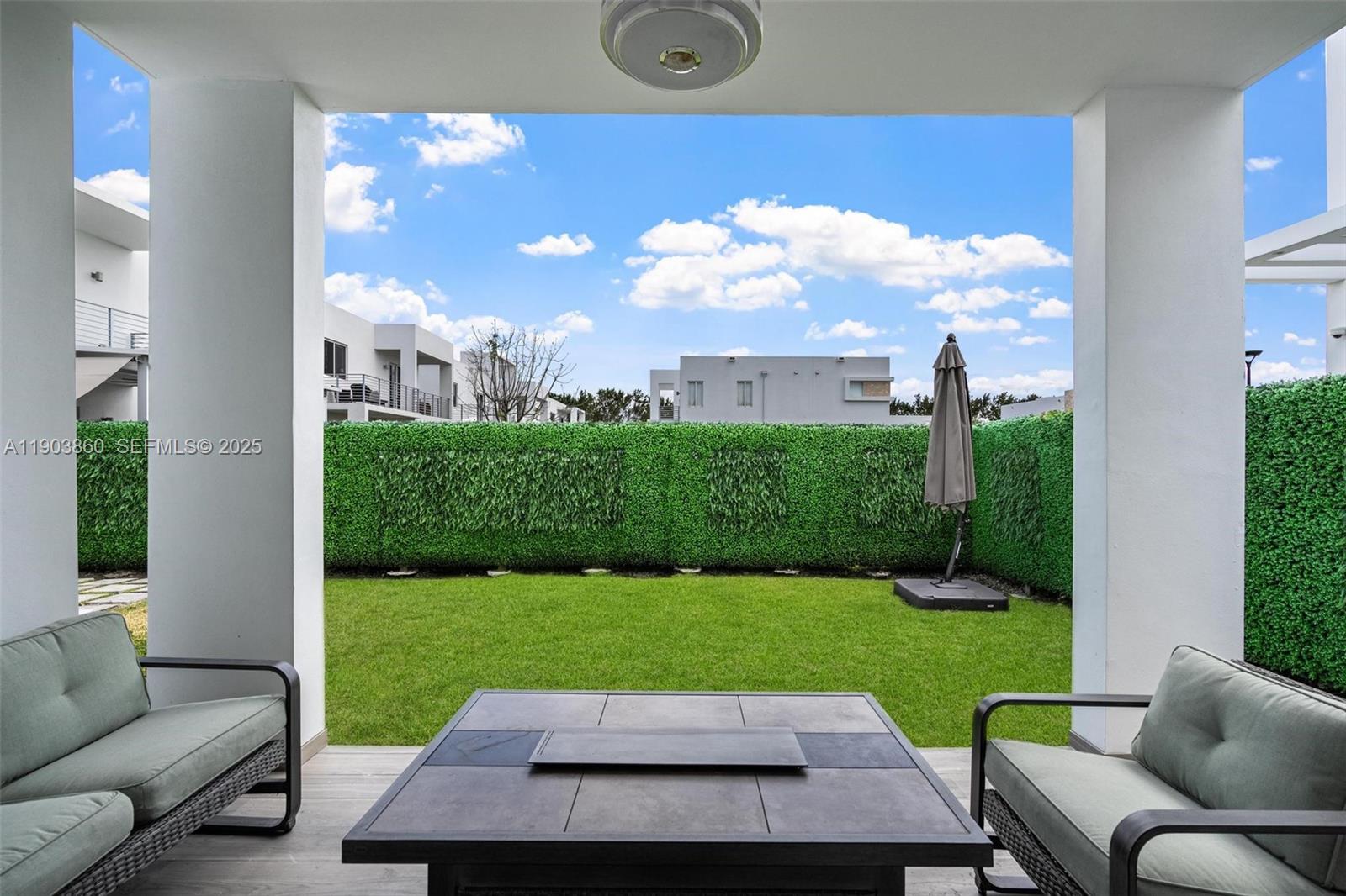 10330 Northwest 68th Street Doral, FL 33178 - Photo 44 of 60 a view of a patio with couches and a table and chairs with garden view