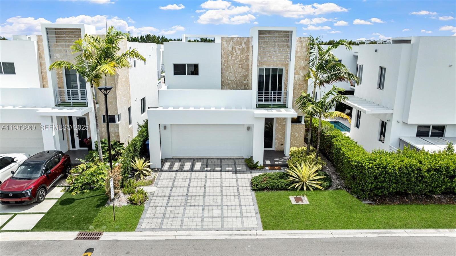 10330 Northwest 68th Street Doral, FL 33178 - Photo 50 of 60 a front view of a house with garden