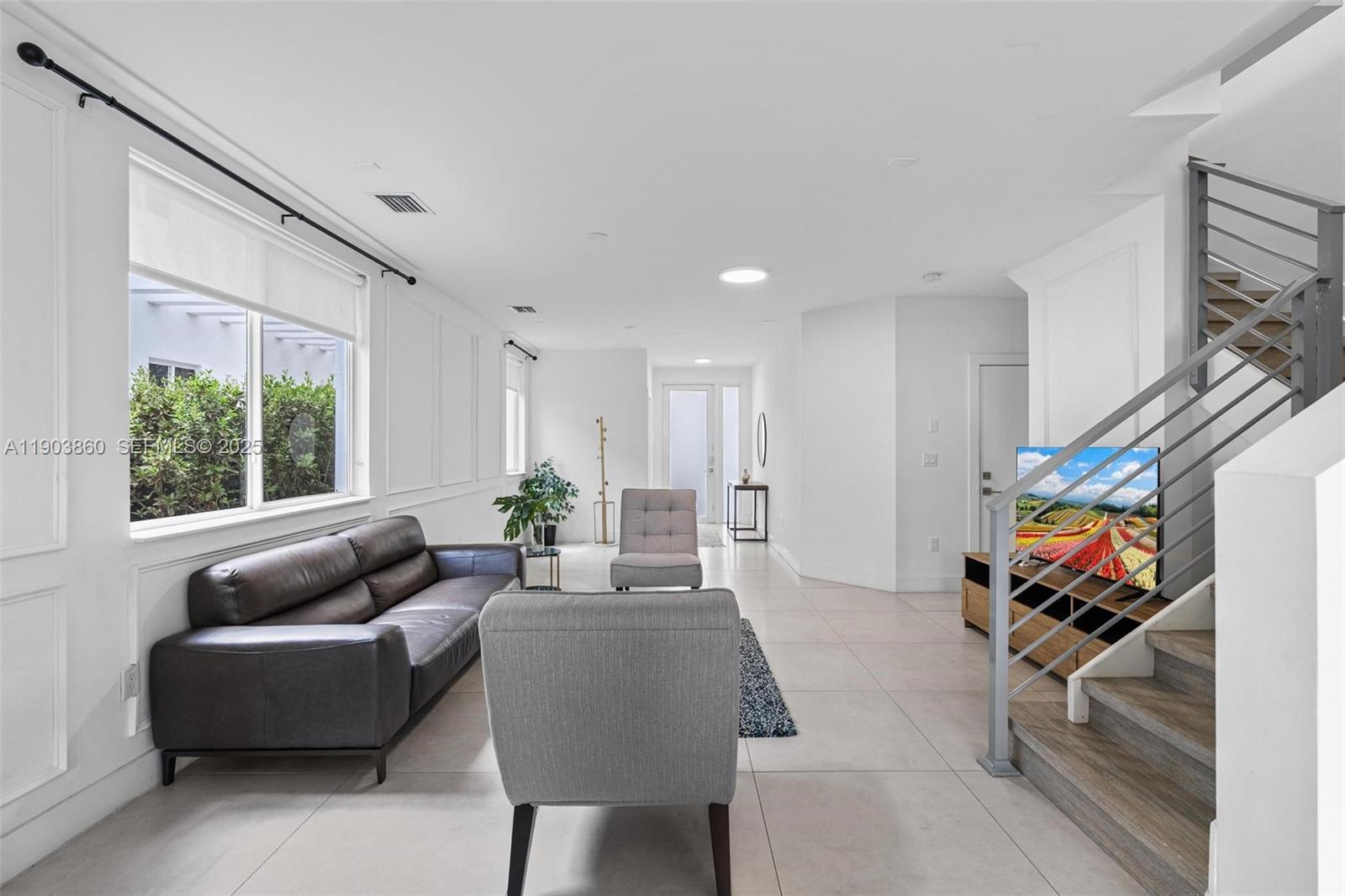 10330 Northwest 68th Street Doral, FL 33178 - Photo 10 of 60 a living room with furniture and a flat screen tv