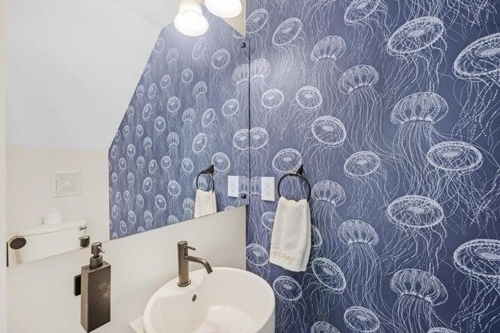 5092 Sunset Village Drive Duck Key, FL 33050 - Photo 25 of 48 a bathroom with a sink and mirror with toilet