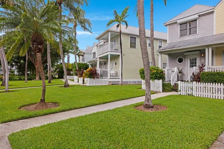 5092 Sunset Village Drive Duck Key, FL 33050 - Photo 3 of 48 a front view of a house with a garden