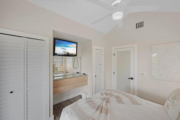 5092 Sunset Village Drive Duck Key, FL 33050 - Photo 31 of 48 a bedroom with a bed and a lamp on the dresser