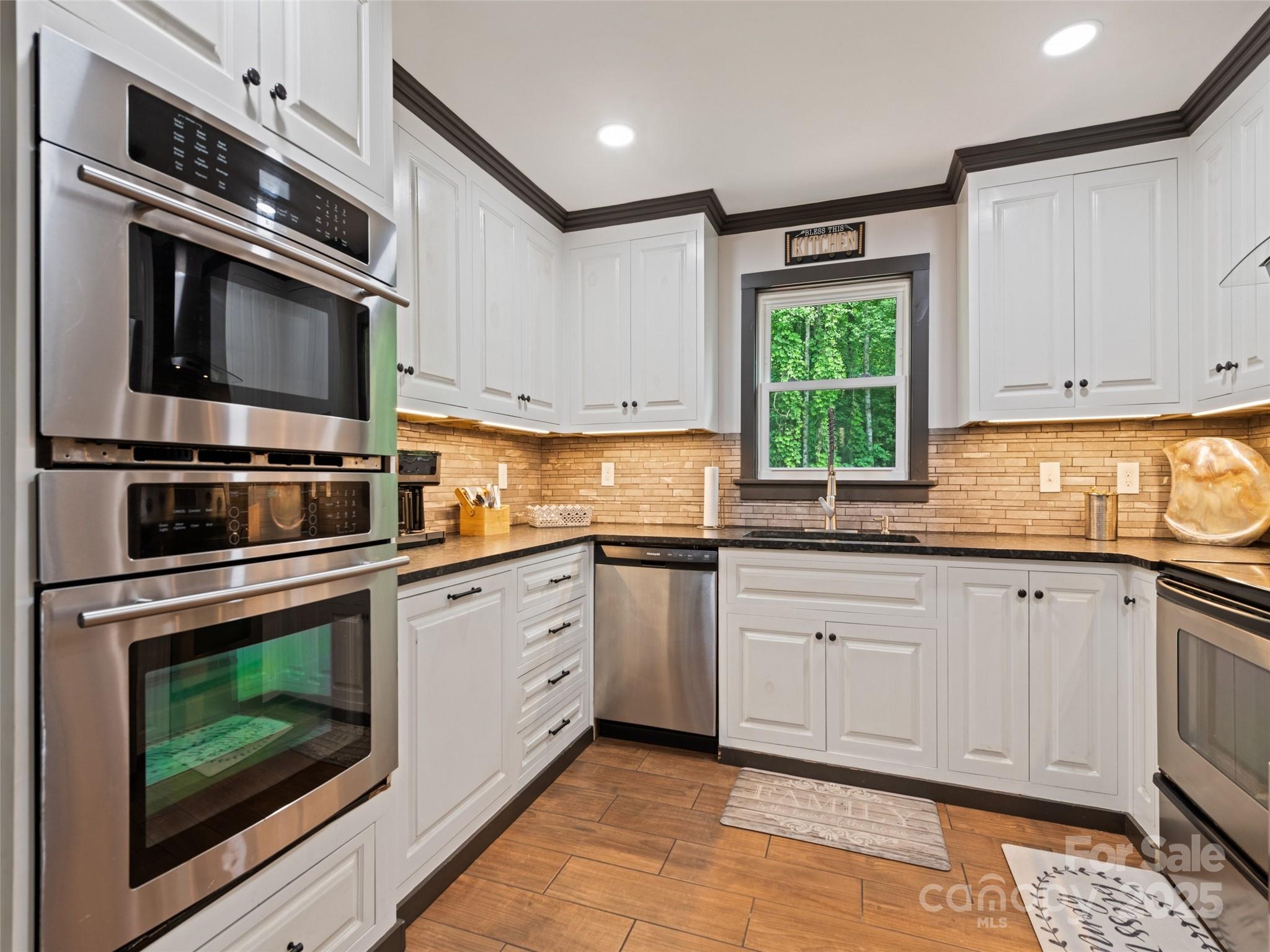 229 Yellow Bird Br Road Sylva, NC 28779 - Photo 16 of 34 a kitchen with granite countertop cabinets stainless steel appliances and a window
