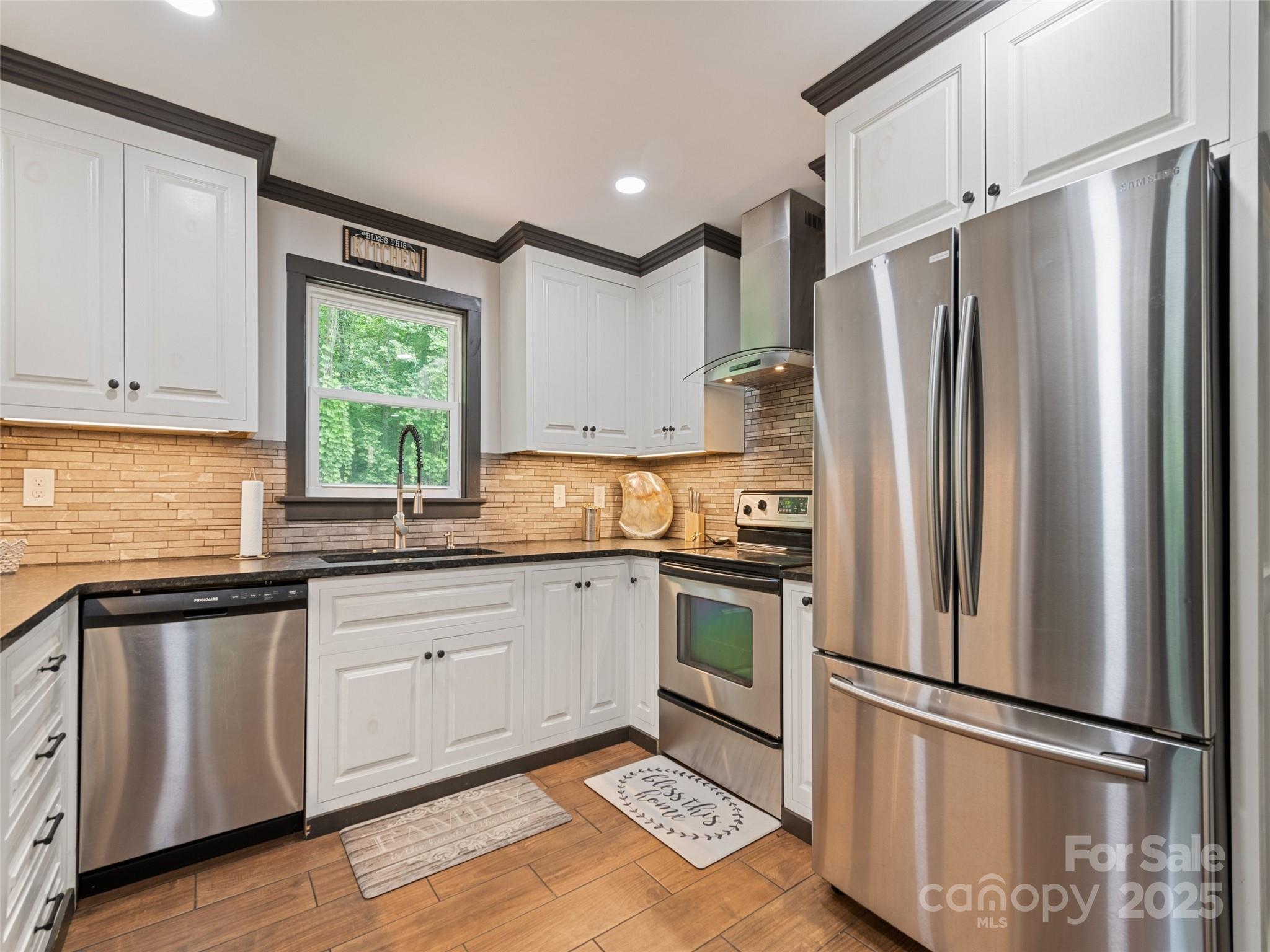 229 Yellow Bird Br Road Sylva, NC 28779 - Photo 17 of 34 a kitchen with stainless steel appliances granite countertop a refrigerator sink and microwave