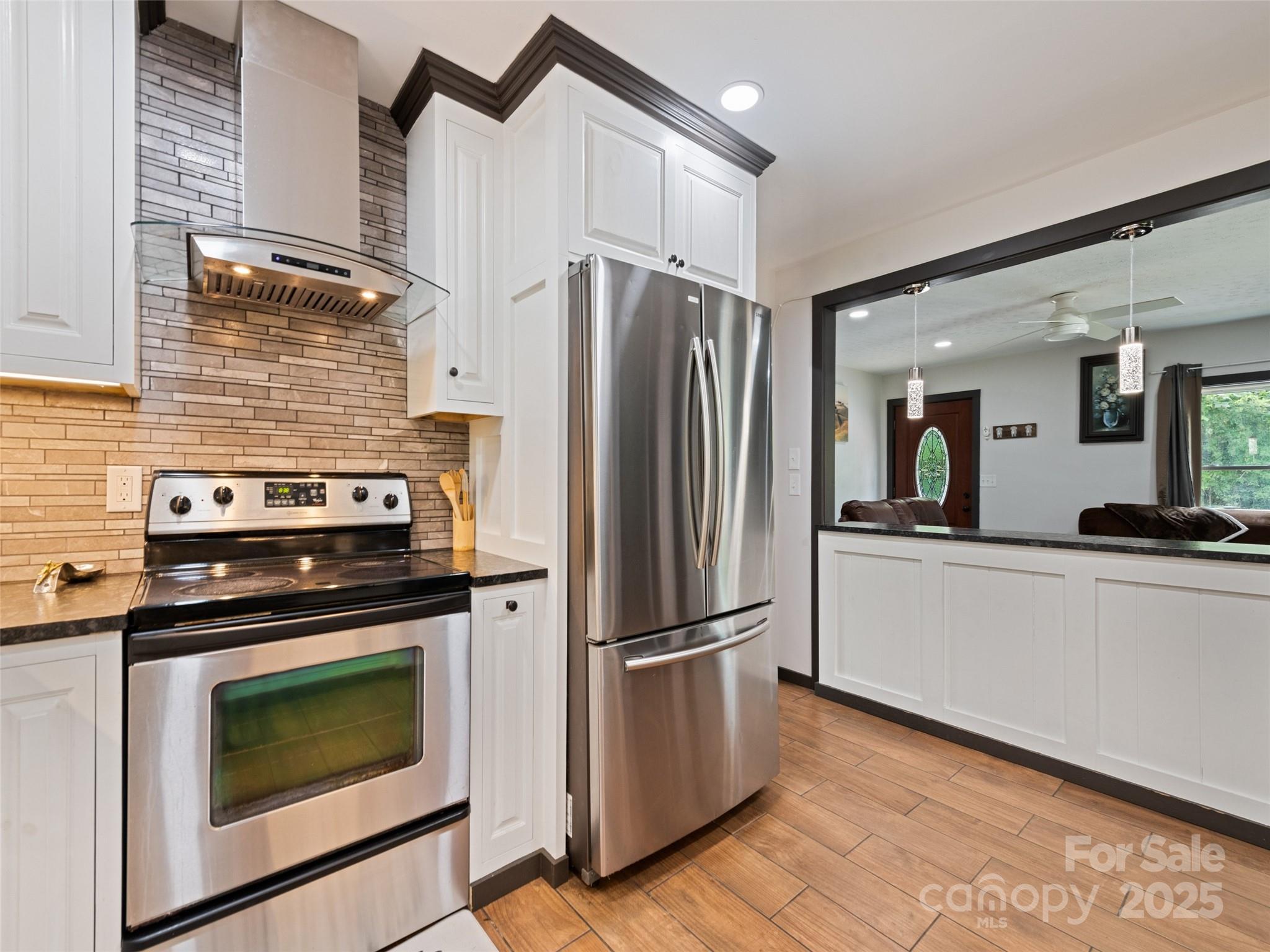 229 Yellow Bird Br Road Sylva, NC 28779 - Photo 18 of 34 a kitchen with granite countertop a stainless steel appliances a refrigerator and a stove top oven