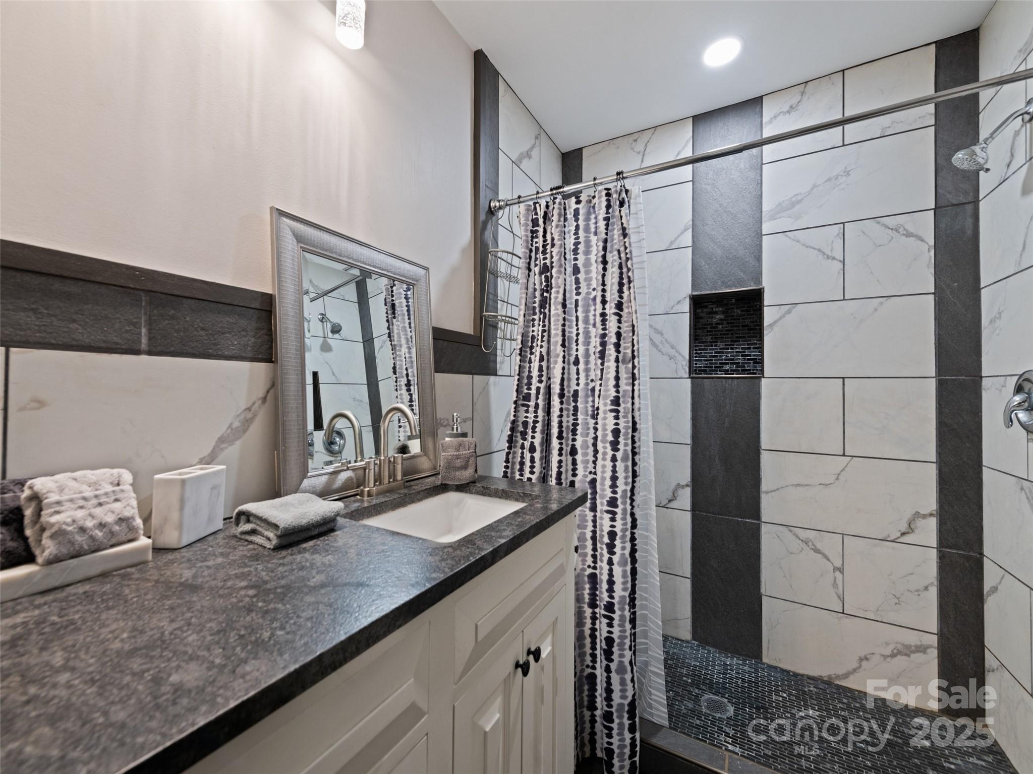 229 Yellow Bird Br Road Sylva, NC 28779 - Photo 20 of 34 a bathroom with a double vanity sink and shower