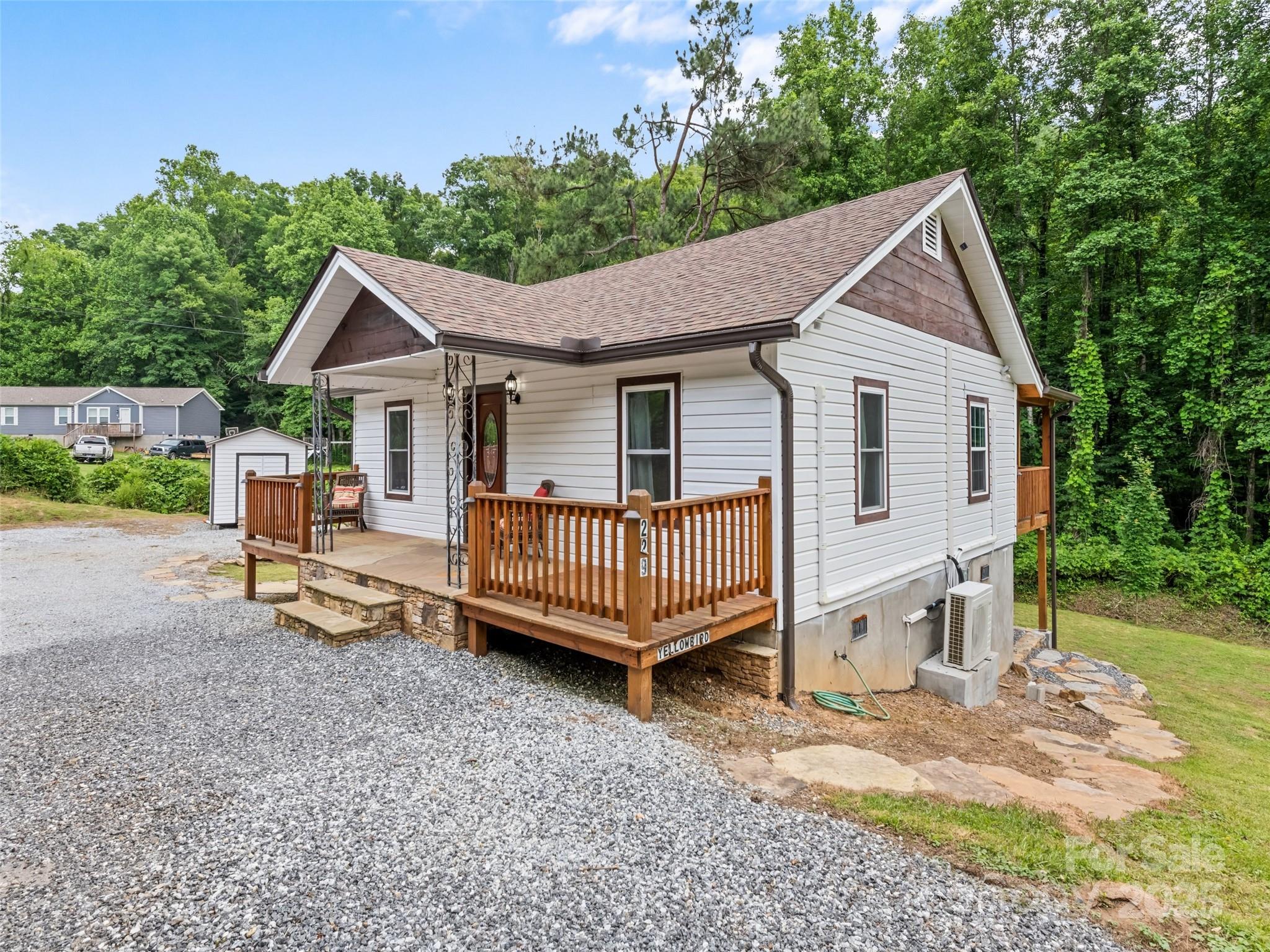229 Yellow Bird Br Road Sylva, NC 28779 - Photo 5 of 34 a view of a house with a yard and deck area under a large tree