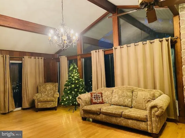 a living room with furniture and a chandelier