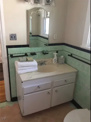 a view of backyard with table and chairs and a large tree
