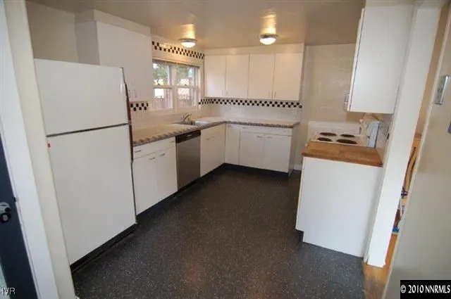 a kitchen with a refrigerator a sink and dishwasher