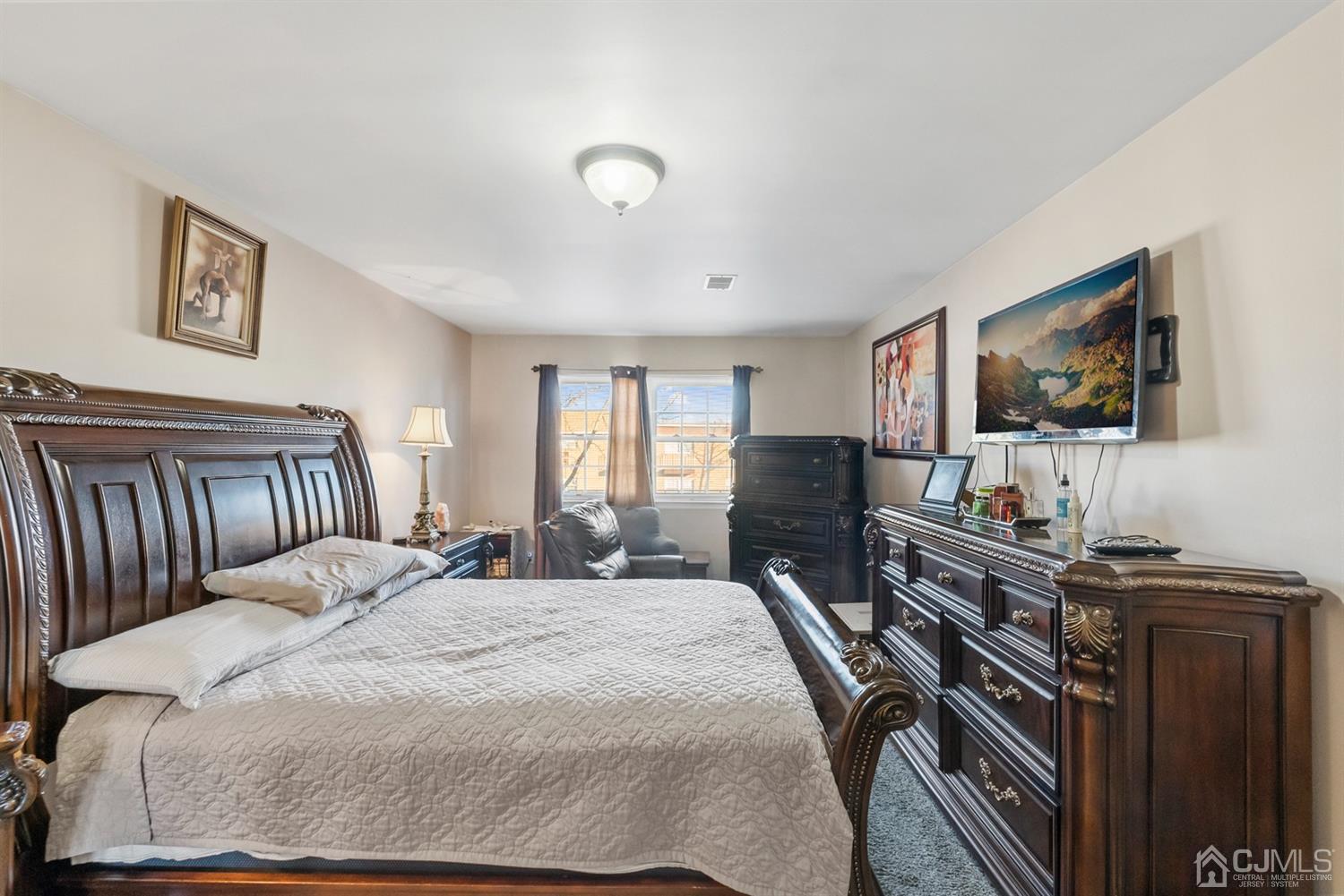 390 College Drive Edison, NJ 08817 - Photo 11 of 17 a bedroom with a bed and a flat screen tv