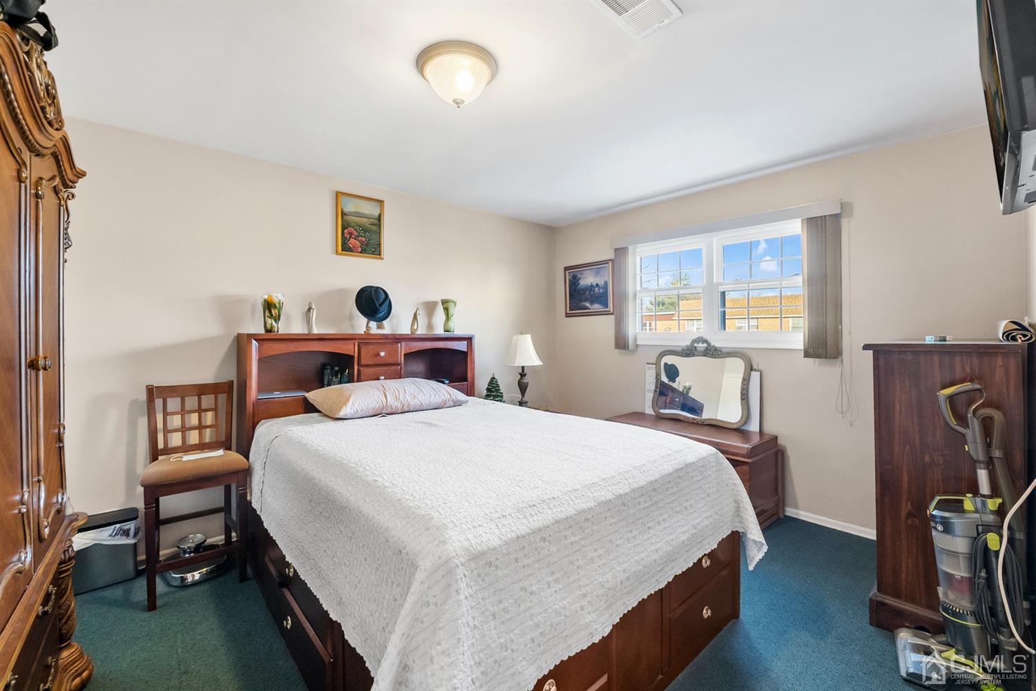 390 College Drive Edison, NJ 08817 - Photo 14 of 17 a bedroom with a bed and a table in it