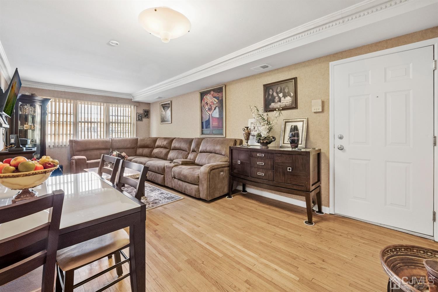 390 College Drive Edison, NJ 08817 - Photo 2 of 17 a living room with furniture and wooden floor