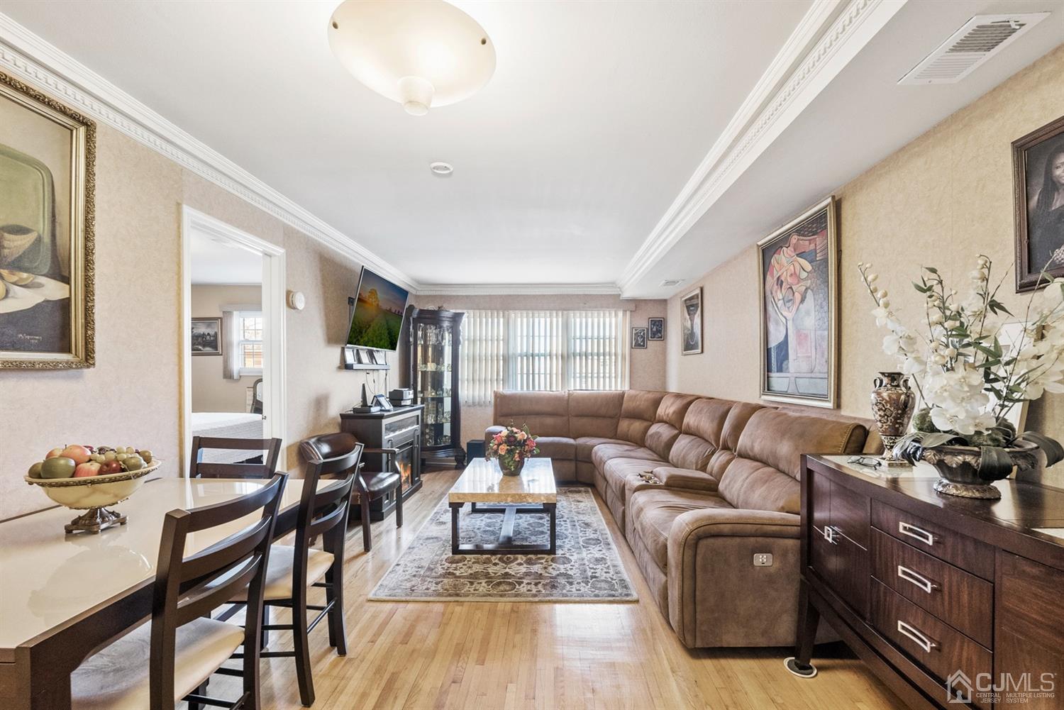 390 College Drive Edison, NJ 08817 - Photo 3 of 17 a living room with furniture or couch and a potted plant