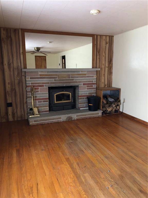 104 Reed Road Fenelton, PA 16034 - Photo 3 of 11 a living room with a fireplace and a wooden floor