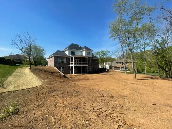 a view of a house with a yard covered with snow in front of house