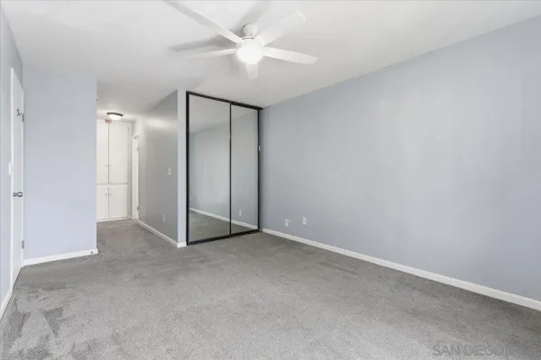 an empty room with fan and fan