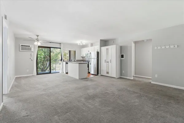 a view of an empty room with a kitchen