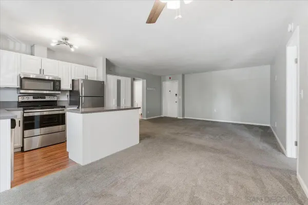 a kitchen with refrigerator and microwave