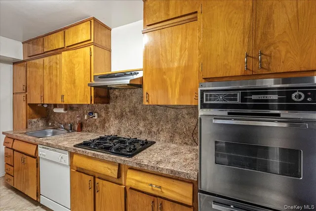 a kitchen with stainless steel appliances granite countertop a stove and a refrigerator