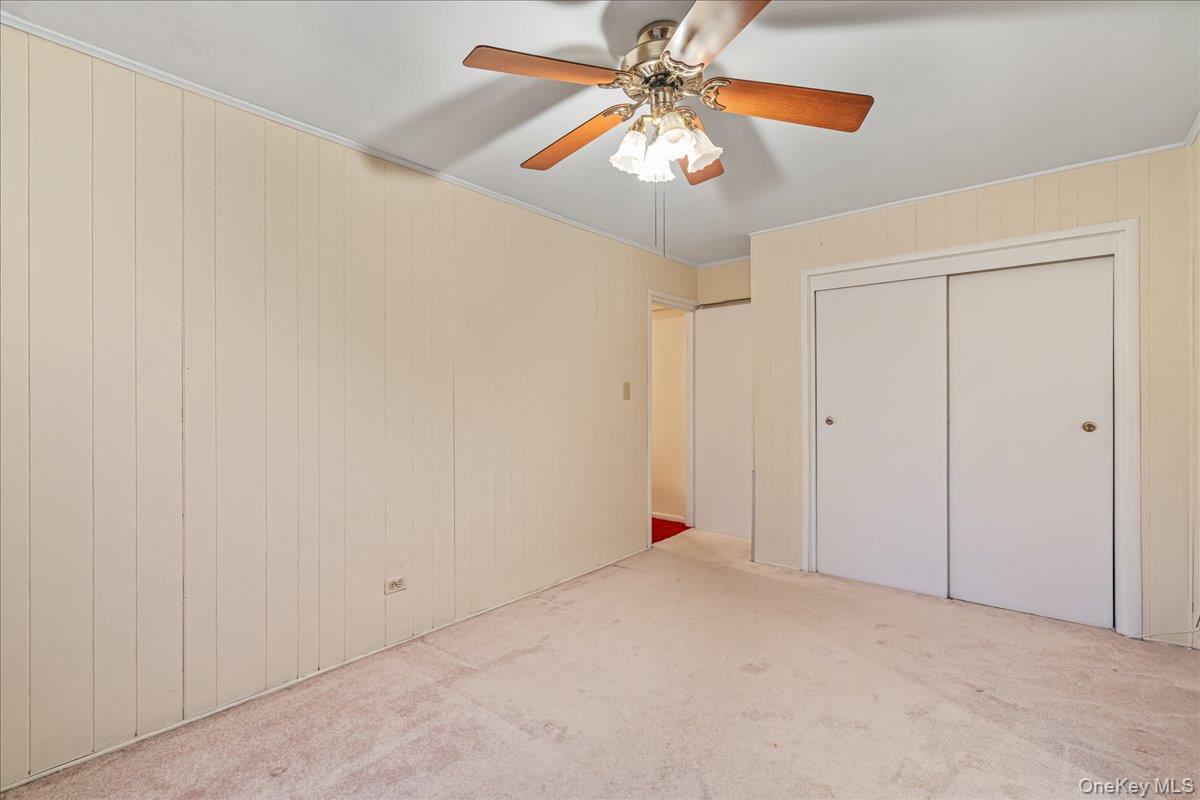 209-25 18th Avenue, Unit 6D Queens, NY 11360 - Photo 21 of 26 an empty room with chandelier fan